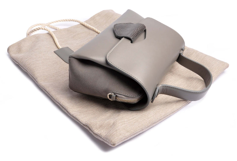Shop Online . ARROW TOTE Bag . Handcrafted from Calf leather in grey . Dust bag